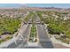 Community entrance with palm trees lining the street in an expansive residential neighborhood at 1073 Via Della Costrella, Las Vegas, NV 89101