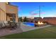 Enjoy outdoor dining and cozy evenings by the fire pit in this backyard setting at 1073 Via Della Costrella, Las Vegas, NV 89101