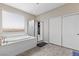 Bright bathroom featuring a soaking tub, walk-in shower, and tiled floors at 1073 Via Della Costrella, Las Vegas, NV 89101
