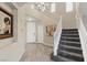 Grand entryway featuring a staircase, neutral paint, and tile flooring at 1073 Via Della Costrella, Las Vegas, NV 89101