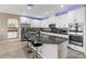 Bright kitchen with a granite island, stainless steel appliances, and white cabinetry at 1073 Via Della Costrella, Las Vegas, NV 89101
