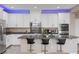 Contemporary kitchen featuring white cabinets, granite countertops, and a large island at 1073 Via Della Costrella, Las Vegas, NV 89101