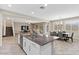 Open-concept kitchen with a granite island, stainless steel appliances, and an adjacent dining area at 1073 Via Della Costrella, Las Vegas, NV 89101