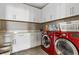 Functional laundry room with white cabinetry, ample counter space, and modern appliances at 1073 Via Della Costrella, Las Vegas, NV 89101