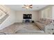 Comfortable living room with a large TV, ceiling fan, and plush seating at 1073 Via Della Costrella, Las Vegas, NV 89101