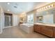 Bright bathroom featuring a soaking tub, double sinks, and a separate glass-enclosed shower at 11238 Meadow Cove St, Las Vegas, NV 89179