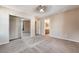 Spacious carpeted bedroom with a ceiling fan, walk-in closet, and an ensuite bathroom at 11238 Meadow Cove St, Las Vegas, NV 89179