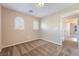 Neutral carpeted bedroom with two arched windows and white trim at 11238 Meadow Cove St, Las Vegas, NV 89179