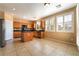 Well-lit kitchen boasts stainless steel appliances, wood cabinets, granite countertops, and a tile backsplash at 11238 Meadow Cove St, Las Vegas, NV 89179