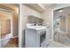 Laundry room featuring modern appliances and ample shelving space at 11238 Meadow Cove St, Las Vegas, NV 89179
