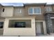 Modern townhome showcasing neutral tones, a covered entry, and contemporary architectural details at 11394 Crimson Ledge Ave, Las Vegas, NV 89138