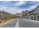 New residential street with modern townhomes, stone retaining wall, and scenic mountain backdrop at 11438 Crimson Ledge Ave, Las Vegas, NV 89138