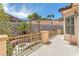 Charming back patio with stone retaining wall, iron railings, and desert landscaping at 1155 Phillip Island St, Henderson, NV 89052