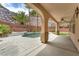 Backyard oasis with a built-in pool, spa, and covered patio with ceiling fan at 1155 Phillip Island St, Henderson, NV 89052
