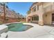 Backyard view featuring a pool, patio, and lovely rock wall landscaping at 1155 Phillip Island St, Henderson, NV 89052