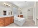 Bright bathroom featuring double vanity sinks, an expansive tub, and natural light at 1155 Phillip Island St, Henderson, NV 89052