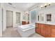 Bright bathroom featuring dual vanities, soaking tub, and natural light at 1155 Phillip Island St, Henderson, NV 89052