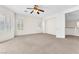 Spacious bedroom featuring neutral carpet, a ceiling fan, and plenty of natural light at 1155 Phillip Island St, Henderson, NV 89052