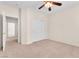 Neutral bedroom with ceiling fan, plush carpet, and sliding closet doors at 1155 Phillip Island St, Henderson, NV 89052