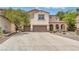 Charming two-story home with a three-car garage, stone accents, and a well-maintained front yard at 1155 Phillip Island St, Henderson, NV 89052
