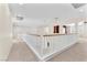 Spacious hallway features white railings, natural light, and neutral carpet at 1155 Phillip Island St, Henderson, NV 89052