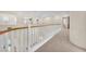 Bright hallway features white railings overlooking the lower level at 1155 Phillip Island St, Henderson, NV 89052