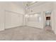 Bright, open living room with tile flooring, tall ceilings, balcony views, and a modern chandelier at 1155 Phillip Island St, Henderson, NV 89052