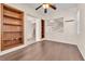 Spacious living room features wood flooring and built-in shelves with an open view to a staircase at 1155 Phillip Island St, Henderson, NV 89052