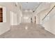 Open living area with tile flooring, high ceilings, balcony views, and a modern chandelier, creates a welcoming space at 1155 Phillip Island St, Henderson, NV 89052