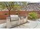 Outdoor kitchen featuring a built-in grill and prep area in the backyard at 1155 Phillip Island St, Henderson, NV 89052