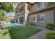 Expansive backyard with artificial turf, a sparkling pool, and a covered patio at 11952 Girasole Ave, Las Vegas, NV 89138