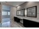 Bathroom with dual vanities, three mirrors, and a walk-in shower at 11952 Girasole Ave, Las Vegas, NV 89138
