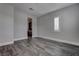 Well-lit bedroom with neutral walls, wood-look floors, and a bright, shuttered window at 11952 Girasole Ave, Las Vegas, NV 89138