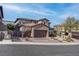 Beautiful two-story home featuring a stone facade and three-car garage, complemented by mature landscaping at 11952 Girasole Ave, Las Vegas, NV 89138