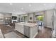 Open-concept living space with kitchen island, living room and dining area offering pool views at 11952 Girasole Ave, Las Vegas, NV 89138