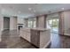 Kitchen island with granite countertop and stainless steel dishwasher is adjacent to a living room and swimming pool at 11952 Girasole Ave, Las Vegas, NV 89138