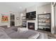 Cozy living room featuring a fireplace, display shelving, and a gray sofa at 11952 Girasole Ave, Las Vegas, NV 89138