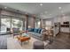 Modern living room featuring stylish decor, a sliding glass door, and dark wood floors at 11952 Girasole Ave, Las Vegas, NV 89138