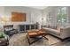 Comfortable living room with stylish furniture, tile floors, and ample natural light from shuttered windows at 11952 Girasole Ave, Las Vegas, NV 89138