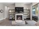 Cozy living room featuring a fireplace, display shelving, and a gray sofa at 11952 Girasole Ave, Las Vegas, NV 89138