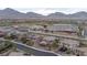 Expansive neighborhood showcasing a mix of residences and a school with mountain views in the background at 11952 Girasole Ave, Las Vegas, NV 89138