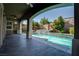 This covered patio features a beautiful pool and stylish tile flooring at 11952 Girasole Ave, Las Vegas, NV 89138