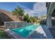 Sparkling backyard pool surrounded by lush landscaping and a decorative stone retaining wall at 11952 Girasole Ave, Las Vegas, NV 89138