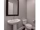 This powder room features a pedestal sink, decorative mirror, and a modern toilet at 11952 Girasole Ave, Las Vegas, NV 89138