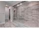 Large walk-in shower with glass enclosure and grey tile at 11952 Girasole Ave, Las Vegas, NV 89138