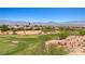 Home is positioned on a golf course with mature desert landscaping and scenic mountain views at 1309 Vista Del Monte Dr, Mesquite, NV 89027