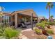 Backyard view features a covered patio, outdoor kitchen and dining space, and lush desert landscaping at 1309 Vista Del Monte Dr, Mesquite, NV 89027