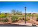 Landscaped backyard with decorative rocks, a lamp post, and green shrubbery at 1309 Vista Del Monte Dr, Mesquite, NV 89027