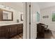 Stylish bathroom with dark wood cabinets, marble countertop and a window at 1309 Vista Del Monte Dr, Mesquite, NV 89027