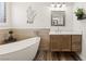 Bathroom with a standalone tub, a decorative wall piece, and a modern vanity at 1309 Vista Del Monte Dr, Mesquite, NV 89027